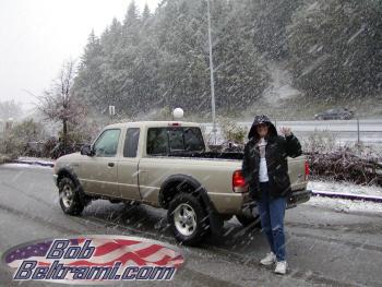 Trish stands in front of the Ranger as the snow falls